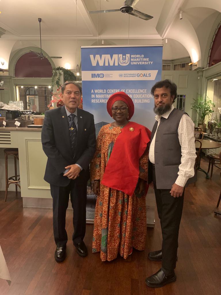 Dr Sajid Hussain, Ms Judith Enaw and Mr Abdulgani Serang, stood together at the graduation ceremony in front of a WMU banner 